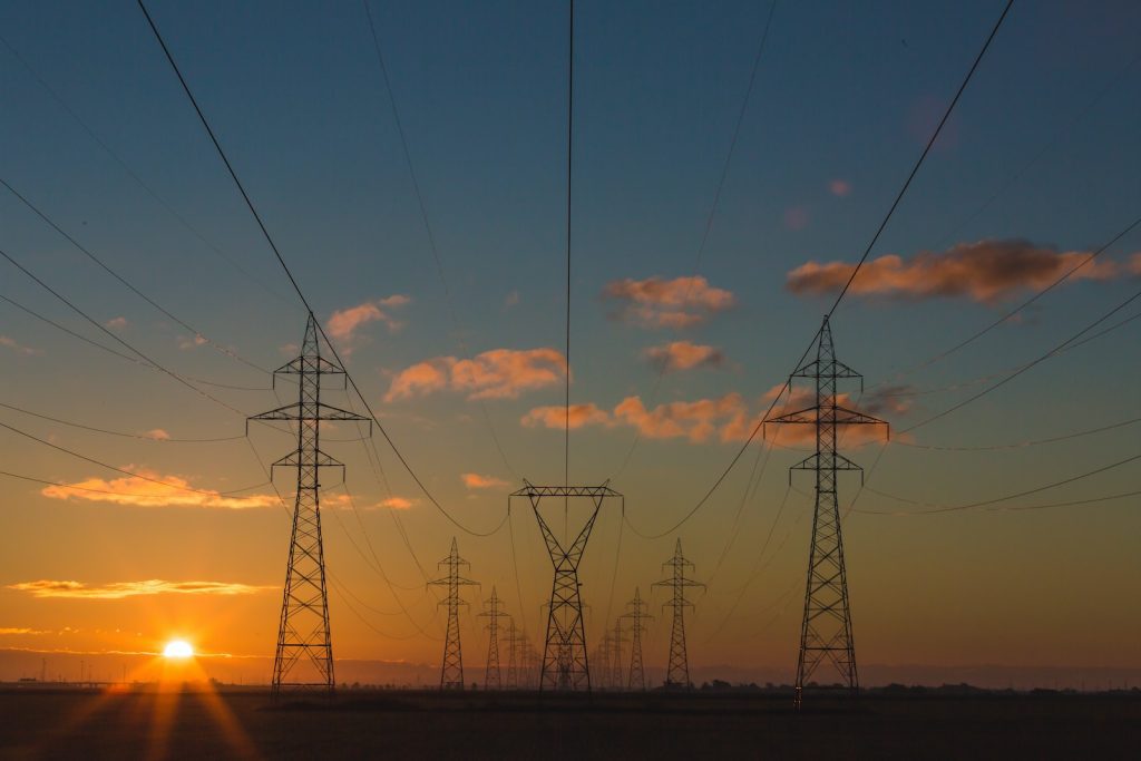 Elektra verbruik door elektriciteitsmasten met ondergaande zon